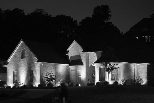 custom-designed architectural lighting illuminating a brick house